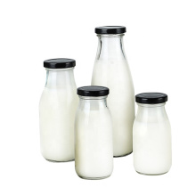 Food grade Clear 250ml round glass bottles with metal lid for cold pressed milk tea juice